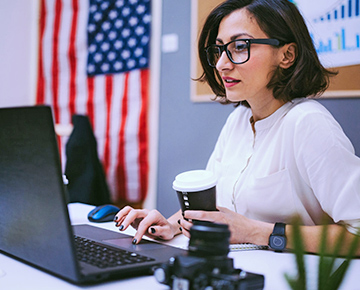 Woman researching immigration options on a laptop in an office