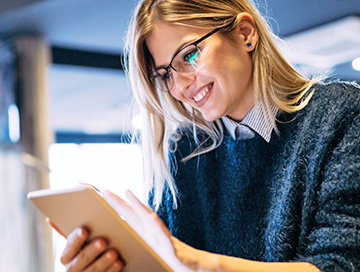 Woman reviewing immigration documents on a tablet
