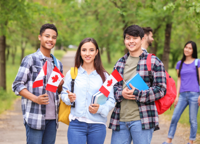Students holding Canadian flags outdoors, representing Study Visa services